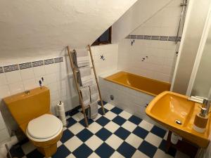 a bathroom with a toilet and a sink and a tub at Clos Sanouva, Fougère in Le Breuil-en-Auge