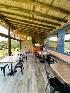 a dining room with wooden tables and chairs at Cúspide in Choachí