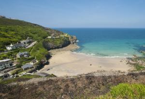 an aerial view of a beach with people on it at Cob Cottage in St. Agnes 