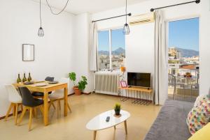 a living room with a table and a couch at Crops Suites in Heraklio