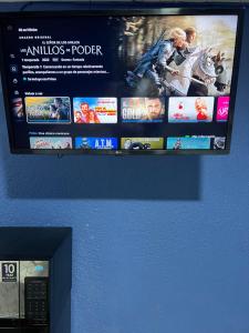a flat screen tv hanging on a wall at Hotel magallanes con cocineta 100 Metros de playa in Acapulco