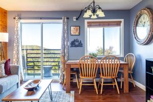 a living room with a dining room table and chairs at WOW Views!!-Mountain Escape-Outdoor Pool-Close to Downtown-WiFi-Cable-Private Balcony in Gatlinburg