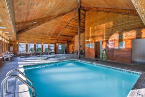 a large swimming pool in a building with a wooden ceiling at WOW Views!!-Mountain Escape-Outdoor Pool-Close to Downtown-WiFi-Cable-Private Balcony in Gatlinburg