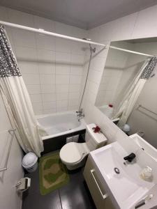 a bathroom with a white toilet and a sink at Apartamento junto a la playa - Vistas Increíbles in Coquimbo