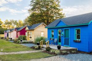 a row of colorful houses in a row at Experience Tiny Living, in Cape Charles, Va in Cape Charles