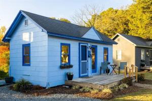 a blue tiny house with a wooden deck at Pet Friendly Tiny Livin 3min from Cape Charles in Cape Charles