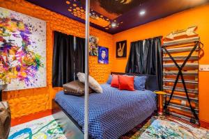 a bedroom with orange walls and a bunk bed at Red House Tiny Home in Cape Charles