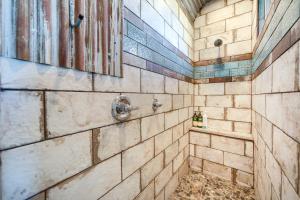 a bathroom with a shower with a tiled wall at Sedona Studio with Amazing View and On-Site Hiking! in Sedona