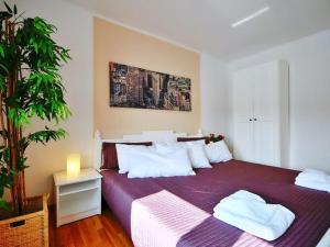 a bedroom with a large purple bed with white pillows at Comfortable apartment with a balcony, very close to the sea, Ustronie Morskie in Ustronie Morskie