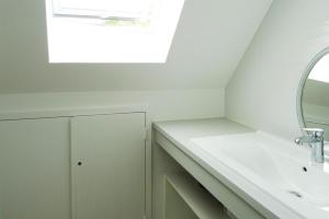 a bathroom with a sink and a mirror at Holiday Home Morgat near Sandy Beach in Morgat +12 photos