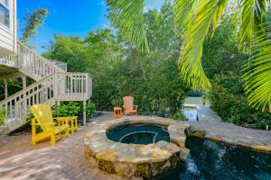a backyard with a hot tub and a staircase at La Buena Vida - Bright Beachy Canal Front Steps to Beach PoolSpa Dock Beach Gear Dogs OK in Anna Maria