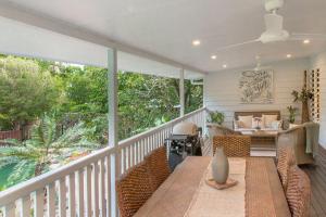 a porch with a table and chairs on a balcony at Malawi House in Edge Hill