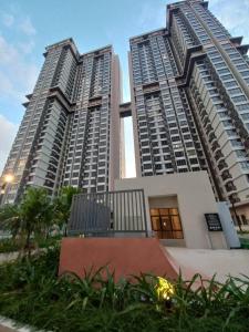 two tall buildings with palm trees in front of them at Rizky D'Bali Homestay @ Bali Residents Melaka in Melaka