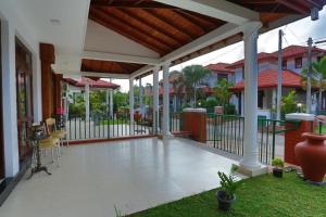 a porch of a house with a fence at Villa Agoura Grand Negombo in Negombo