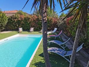 - un groupe de chaises assises à côté de la piscine dans l'établissement Magnifique villa avec piscine en bord de Mer, à Lucciana