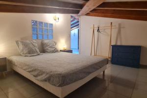 a bedroom with a bed with a blue dresser and a window at Magnifique villa avec piscine en bord de Mer in Lucciana +34 photos