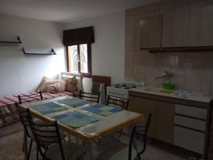 a kitchen with a table and some chairs and a table and a kitchen at FREEDOM Joa in Río Gallegos