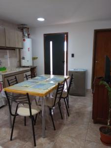 a kitchen with a table and chairs in a room at FREEDOM Joa in Río Gallegos