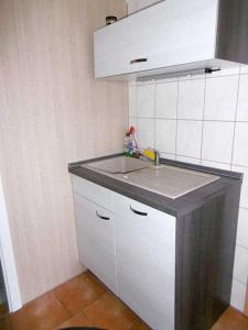 a kitchen with a sink and a counter top at Ruegen_Fewo 42 in Rambin