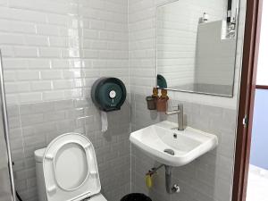 een badkamer met een toilet en een wastafel bij Baan Tipsukon in Ko Larn
