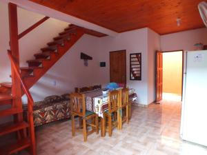 a living room with a table and chairs and a staircase at Madre Selva Iguazu in Puerto Iguazú