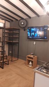a living room with a flat screen tv on the wall at PRIMAVERA LIVING in Medellín
