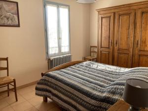 a bedroom with a bed and a window at Maison Ruoms, 3 pièces, 4 personnes - FR-1-697-2 in Ruoms