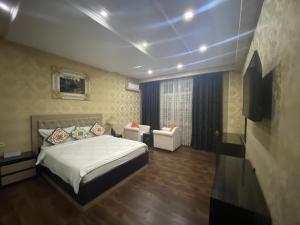 a bedroom with a bed and a couch in it at Sunrise Apartments in Dushanbe