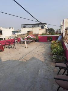 a patio with tables and chairs on a building at Thomas Home Stay in Agra