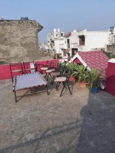 a group of chairs and tables on a roof at Thomas Home Stay in Agra