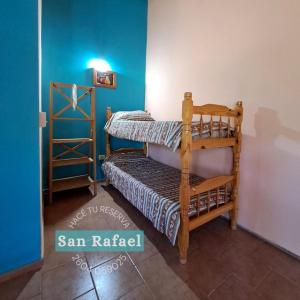1 dormitorio con litera y pared azul en Departamento Céntrico en San Rafael