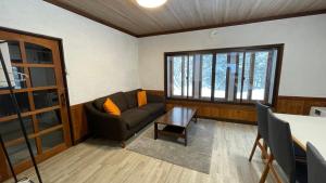 a living room with a couch and a table at ZU-THONES HAKUBA ANNEX in Yotsuya +7 photos