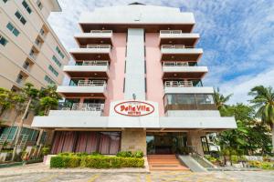 a pink building with a marina villa sign on it at Bella Villa Metro in Pattaya North