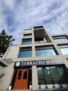 a building with a sign that reads terraatlantic suites at Terrazzo Suits in Ahmedabad