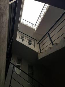an empty building with a large window and stairs at Departamentos fresno! Tu mejor opción in Toluca