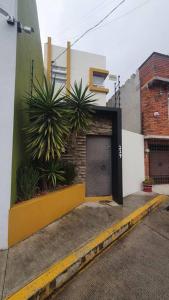 a building with a door and plants on the side of it at Departamentos fresno! Tu mejor opción in Toluca