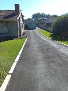 an empty driveway in front of a house at TPOKAY Self Catering Holiday Home in Pietermaritzburg