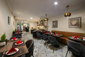 a restaurant with tables and chairs in a room at San Palace Hotel & Spa in Hanoi