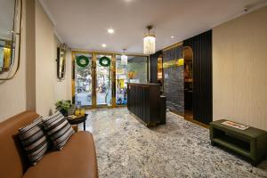 a living room with a couch and a table at San Palace Hotel & Spa in Hanoi