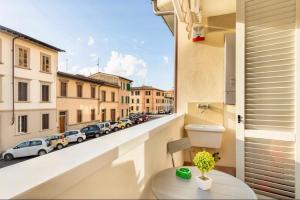 a balcony with a toilet and a view of a street at Florence Green Apartment in Florence