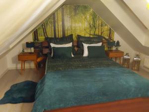 カルパチにあるEl-Jar 2 Mięta Góralkiのベッドルーム1室(壁に絵画が描かれた緑のベッド1台付)
