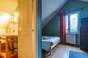 a small room with a bed and a window at B&B des Marcs d'Or in Dijon