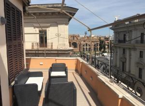 a balcony with chairs and a view of a city at Esposizione Roof in Rome