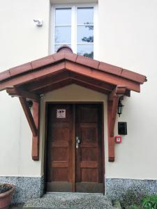 awning over the door of a house at Prudentia Apartments Brzozowa in Warsaw