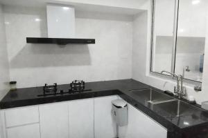 a kitchen with a sink and a counter top at Rawang Conner lot homestay in Rawang