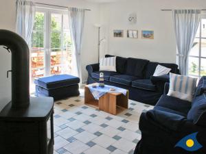 a living room with a couch and a wood stove at Haus Klabautermann in Heringsdorf