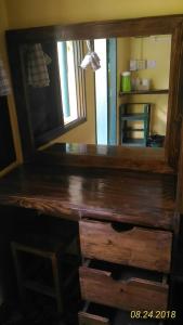 a wooden dresser with a mirror on top of it at Island Lodge in Ko Chang