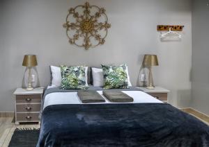 a bedroom with a large bed with two night stands at Biki Plek 2 in Kimberley