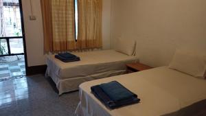 a room with two beds and a window at Kradan Beach Resort in Koh Kradan