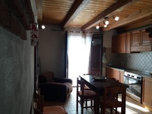 a kitchen with a table and chairs and a dining room at La Nicchia in Gerace +8 photos